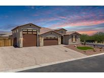 Charming single-Gathering home featuring a three-car garage, desert landscaping, and beautiful brick driveway at 12516 W Mclellan Ct, Glendale, AZ 85307