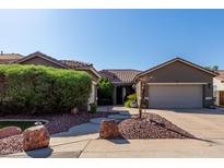 Charming single-story home with a well-manicured front yard and a two-car garage at 13629 W San Miguel Ave, Litchfield Park, AZ 85340