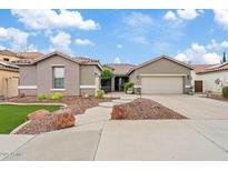 Charming single-story home with a well-manicured front yard and a two-car garage at 13629 W San Miguel Ave, Litchfield Park, AZ 85340