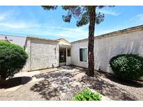 Charming single-story home featuring a gated entrance, textured walls, and mature landscaping at 15801 N 29Th N St # 20, Phoenix, AZ 85032