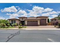 Charming single-story home featuring a three-car garage, desert landscaping, and a brick driveway at 16141 N 183Rd Dr, Surprise, AZ 85388