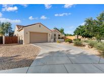 Charming single-story home with a well-maintained front yard and a two-car garage at 16158 W Coronado Rd, Goodyear, AZ 85395