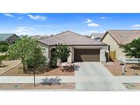 Charming single-story home with a tile roof, a two-car garage, and desert landscaping at 21104 E Poco Calle --, Queen Creek, AZ 85142