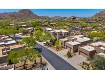 Aerial view of homes in a planned community surrounded by desert landscape and mountains at 27892 N 108Th Way, Scottsdale, AZ 85262