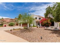 Charming home featuring a landscaped front yard, mature trees, and a two-car garage at 3514 E Desert Willow Rd, Phoenix, AZ 85044