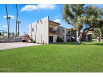 Lovely condo with a green lawn, mature trees, and a well maintained facade at 3737 E Turney Ave # 206, Phoenix, AZ 85018