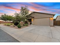 Charming single-story home featuring a well-maintained lawn, desert landscaping, and a two-car garage at 41138 N Soap Berry St, Queen Creek, AZ 85140