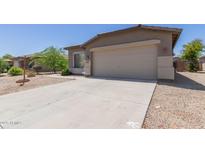 Charming single-story home with a two-car garage and a well-maintained front yard at 42347 W Bunker Dr, Maricopa, AZ 85138