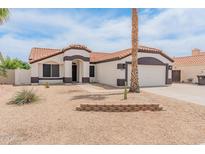Charming single-story home with a well-maintained yard and a two car garage at 9231 W Grovers Ave, Peoria, AZ 85382