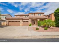 Beautiful home with a three car garage, well-manicured lawn and attractive desert landscaping at 9622 S 46Th Ln, Laveen, AZ 85339