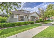 Well-maintained home features manicured landscaping, charming stone accents, and a covered porch at 1143 S Annie Ln, Gilbert, AZ 85296
