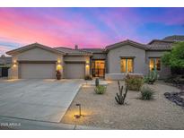 Beautiful desert home boasts a three-car garage, landscaped yard, and modern design elements, creating an inviting curb appeal at 14523 E Charter Oak Dr, Scottsdale, AZ 85259