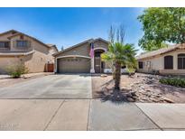 Charming single-story home featuring a well-maintained yard, desert landscaping and an attached two-car garage at 15743 N 165Th Ln, Surprise, AZ 85388