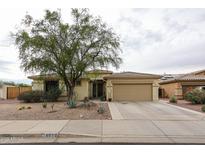 Inviting single-story home featuring a low-maintenance desert landscape and a two-car garage at 18550 W Mcneil St, Goodyear, AZ 85338
