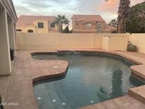 Inviting backyard pool with a charming water feature for relaxation and entertainment at 2127 W Peninsula Cir, Chandler, AZ 85248