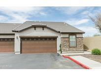 Attached garage doors, stone accents, and well-maintained landscaping enhance this beautiful home at 2725 E Mine Creek Rd # 1208, Phoenix, AZ 85024