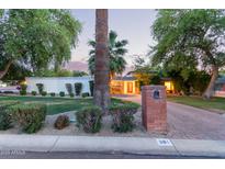 Charming home with brick driveway, lush landscaping, and inviting curb appeal at 301 W Royal Palm Rd, Phoenix, AZ 85021