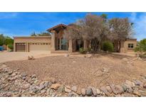 Beautiful desert home with drought-resistant landscaping and a three-car garage at 4922 W Fallen Leaf Ln, Glendale, AZ 85310