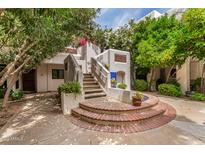 Charming home entrance featuring red brick steps, lush greenery, and a welcoming atmosphere at 5200 S Lakeshore Dr # 206, Tempe, AZ 85283