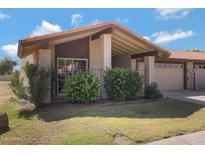 Charming single-story home featuring a well-maintained front yard and a two-car garage at 5231 E Tamblo Dr, Phoenix, AZ 85044