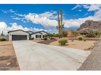 Charming single-story home with a two-car garage and a well-manicured desert landscape at 5670 E Singletree St, Apache Junction, AZ 85119