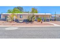 Charming single-story home featuring desert landscaping and a welcoming covered porch entry at 6921 W Wanda Lynn Ln, Peoria, AZ 85382