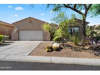 Charming single-story home featuring desert landscaping and a two-car garage at 7291 E Eagle Feather Rd, Scottsdale, AZ 85266