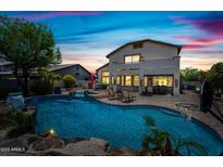 Inviting backyard featuring a sparkling pool, lush landscaping, and a covered patio for ultimate relaxation and entertainment at 7342 E Norwood St, Mesa, AZ 85207