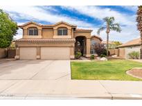 Two-story home featuring a well-manicured lawn and three-car garage at 7460 E Kiowa Ave, Mesa, AZ 85209