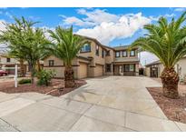 Two-story home featuring a spacious concrete driveway, desert landscaping, and a two-car garage at 8214 S 48Th Dr, Laveen, AZ 85339