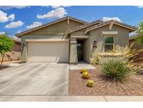 Charming single-story home featuring a two-car garage and desert landscaping at 9418 W Minnezona Ave, Phoenix, AZ 85037
