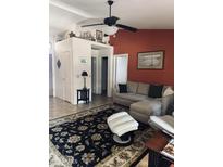 Comfortable living room featuring neutral-toned sectional, decorative rug, and a cozy ottoman at 14617 S 35Th Pl, Phoenix, AZ 85044