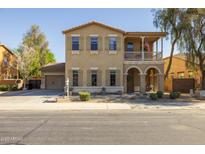 Charming two-story home featuring a welcoming porch, desert landscaping, and neutral color palette at 16206 W Cocopah St, Goodyear, AZ 85338