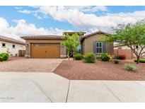 Beautiful single-story home featuring a desert landscaped yard, tile roof and a two car garage at 18453 W Elwood St, Goodyear, AZ 85338