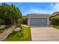 Beautiful single-story home featuring a blue garage door and desert landscaping at 19606 N 23Rd Way, Phoenix, AZ 85024