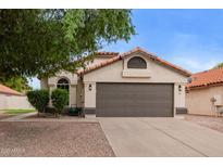 Charming single-story home featuring a well-manicured front yard and a neutral paint scheme at 2027 S Rowen St, Mesa, AZ 85209