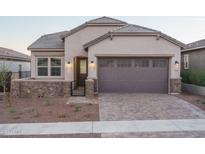 Charming single-Gathering home featuring a gray garage door and brick-paved driveway at 20961 W Pasadena Ave, Buckeye, AZ 85396