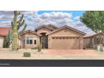 Charming single-story home with a well-manicured front yard and a two-car garage in a sunny neighborhood at 2395 E Hancock Trl, Casa Grande, AZ 85194