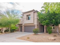 Charming two-story home featuring a tile roof, desert landscaping, and a two-car garage at 28136 N 90Th Ln, Peoria, AZ 85383