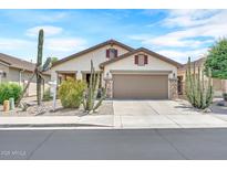 Charming single-story home featuring a two-car garage, desert landscaping, and a neutral color palette at 660 W Twin Peaks Pkwy, San Tan Valley, AZ 85143