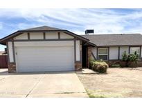 Charming single-Gathering home featuring a 2-car garage and a well-maintained front yard at 7013 W North Ln, Peoria, AZ 85345