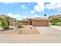Charming single-story home with a well-maintained yard and a two-car garage at 7214 W Crest Ln, Glendale, AZ 85310