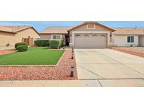 Single-story home with a two-car garage, low maintenance yard, and desert landscaping at 10521 W Ross Ave, Peoria, AZ 85382