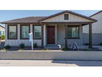 Charming single-story home with a well-manicured front yard and covered porch, creating inviting curb appeal at 1057 S 151St Ln, Goodyear, AZ 85338