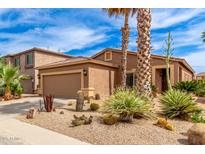 Charming single-Gathering home with desert landscaping, palm trees, and a two-car garage at 1173 E Daisy Way, San Tan Valley, AZ 85143