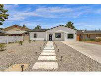 Charming single-story home featuring a modern exterior with a well-maintained gravel yard and paver walkway at 2122 W Virginia Ave, Phoenix, AZ 85009