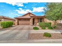 Charming single-Gathering home featuring a low maintenance front yard, two car garage, and covered porch at 21667 S 225Th Way, Queen Creek, AZ 85142
