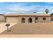 Charming single-story home featuring an arched porch, desert landscaping, and a two-car garage at 2210 W Tonto Ln, Phoenix, AZ 85027