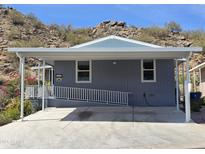 Charming single-level home featuring desert landscaping and covered parking space with disability access at 2233 E Behrend Dr # 203, Phoenix, AZ 85024