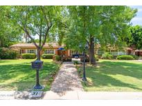 Charming brick home with a lush front yard, mature trees, and a welcoming brick pathway at 31 W Marlette Ave, Phoenix, AZ 85013